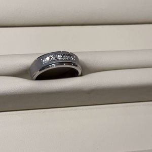 Size 7, can be resized. Never worn. 10K white gold, 5 diamond set, satin finish.